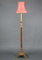 An Italian style carved and painted gilt wood standard lamp raised on a circular base with 3