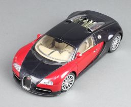 An Autoart 1:18 scale model of a Bugatti EB 16.4 Veyron showcar, in black and red, numbered 7645,