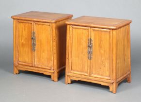 A pair of Chinese rectangular hardwood cabinets, the interiors fitted shelves and 2 drawers,
