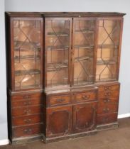 A Georgian mahogany triple breakfront library secretaire bookcase with moulded and dentil cornice,