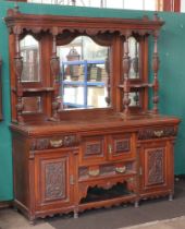 An Edwardian heavily carved walnut chiffonier sideboard the raised back fitted 3 arched plate