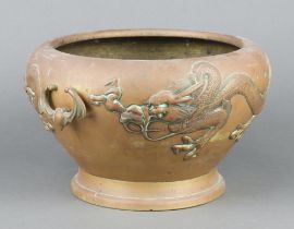 A Japanese polished bronze twin handled urn decorated a dragon and with bat handles 18cm x 30cm