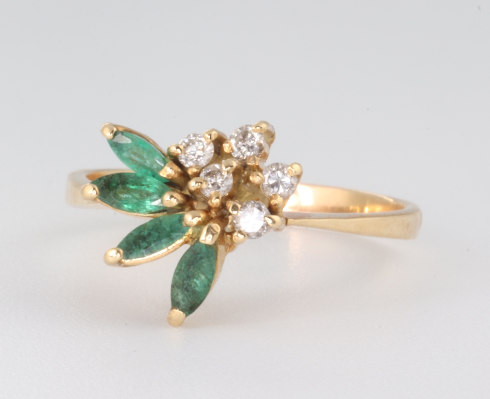 A yellow metal emerald and diamond floral ring 2.9 grams, size N