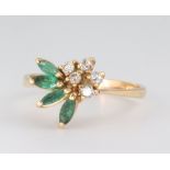 A yellow metal emerald and diamond floral ring 2.9 grams, size N