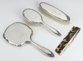 An Art Deco Alpaca dressing table set comprising hand mirror, hair brush, clothes brush and comb