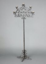 A blacksmith made wrought iron arch shaped 5 light standard lamp, raised on spiral turned column,