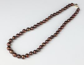 A strand of brown cultured pearls with a yellow metal 375 clasp 54cm