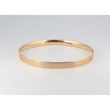 A 9ct yellow gold engraved bangle 70mm diam., 17.2 grams