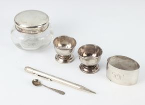 A silver napkin ring Birmingham 1935, a lidded jar, 2 bowls and a salt together with a propelling