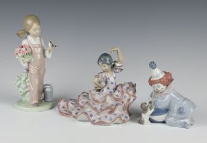 A Lladro figure of a boy clown 5278 11cm, ditto ballerina 5390 15cm and a girl with bird 5217 18cm
