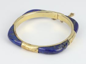 A yellow metal mounted lapis lazuli bangle 65mm