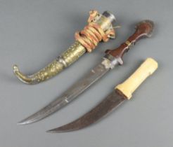 An Eastern Jambiya knife with 23cm blade contained in a gilt metal scabbard (section of metal