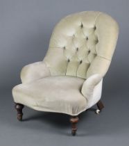 A Victorian tub back chair upholstered in green buttoned material, raised on turned supports 79cm