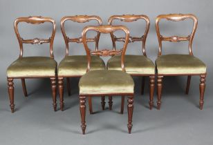 A set of 5 Victorian style mahogany spoon back dining chairs with carved mid rails and overstuffed