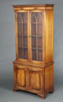 A Georgian style mahogany display cabinet the upper section with moulded and dentil cornice fitted