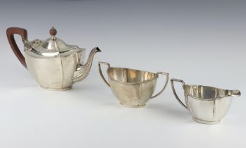 A silver 3 piece tea set with fruitwood mounts, Birmingham 1927 and 1928, Maker Barker Brothers