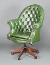 A Victorian style tub back revolving office chair upholstered in green buttoned leather 117cm h x