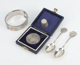 A commemorative silver medallion Birmingham 1947, 2 spoons, a thimble and bracelet 87 grams