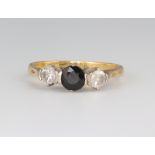 A yellow metal 18ct sapphire and diamond ring, the sapphire 0.5ct, the diamonds each 0.25ct, size M,