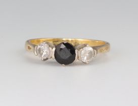A yellow metal 18ct sapphire and diamond ring, the sapphire 0.5ct, the diamonds each 0.25ct, size M,