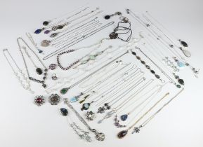A quantity of silver mounted pendants, necklaces, bracelets, brooches etc