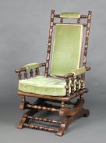 A 19th Century American turned beech rocking chair upholstered in green material 107cm h x 53cm w