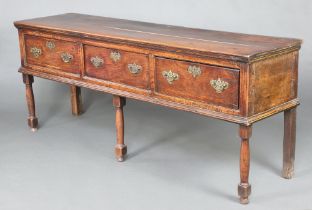A 17th/18th Century oak dresser base, the top formed of 2 planks fitted 3 long drawers with