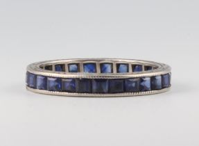 A white metal princess cut sapphire eternity ring, comprising 22 stones, each approx. 0.01ct, size Q