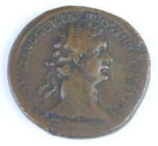 A brass sestertius coin for Domitianus 81-96AD, the reverse side shows Domitianus (left) holding a