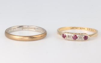 A yellow metal 18ct ruby and diamond ring together with a platinum wedding band sizes O and M, 3.6