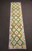 A green, brown and white ground Maimana Kilim runner with all over diamond design 400cm x 90cm