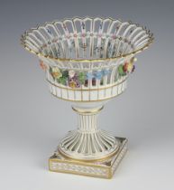 A modern German porcelain pierced centrepiece with applied floral decoration, raised on a square