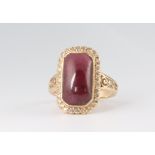 A yellow metal rounded rectangular cabochon cut garnet and diamond cluster ring, size O, 4.8 grams