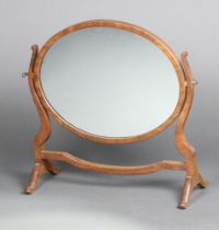 A Georgian style oval plate dressing table mirror contained in a mahogany swing frame 50cm h x