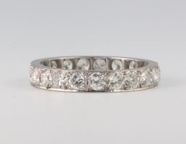 A white metal 21 stone diamond eternity ring, approx. 1ct, 3.4 grams, size P