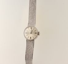 A lady's 9ct white gold Bulova wristwatch on a mesh bracelet, in a 15mm case, 17.6 grams including