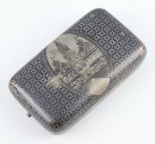 A Russian silver niello rounded rectangular cigarette box decorated with a palace scene and