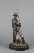 A 20th Century bronze figure of an angler raised on an oval marble base 44cm h