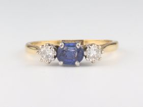 A yellow metal 18ct sapphire and diamond ring, the centre stone approx. 0.5ct, the 2 diamonds each