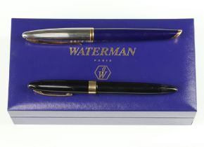 A Waterman blue and steel fountain pen with 18ct nib, boxed, a Sheaffer black ditto with 14ct nib (