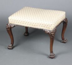 A 19th Century Georgian style rectangular carved mahogany stool raised on cabriole supports, the