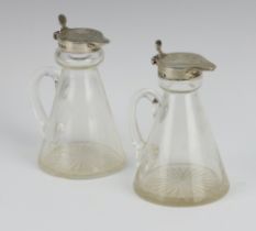 A pair of silver mounted glass toddy decanters Birmingham 1933 and 1934, 10cm One is chipped
