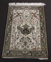 A Persian white and black ground floral patterned rug decorated a mosque lamp to the centre 163cm