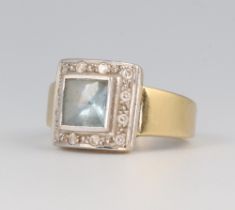 A yellow metal square aquamarine and diamond cocktail ring, the centre stone approx. 1ct, surrounded