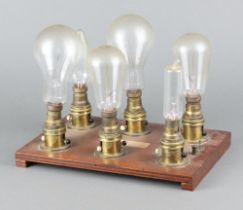 Six vintage light bulbs mounted on a wooden base