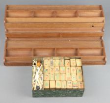 A Mahjong set comprising 143 bamboo tiles, approx. 117 bone counting sticks and 4 walls