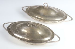A pair of William IV oval silver dishes/entrees and covers with chased armorials and reeded handles,