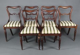 A set of 6 Victorian carved rosewood spoon back dining chairs with carved mid rails and drop in