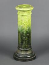 An Edwardian Burmantofts green glazed pottery jardiniere stand with floral decoration, the base