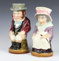 A pair of Sarreguemines character jugs of a seated lady and gentleman 3430 and 3329, 30cm